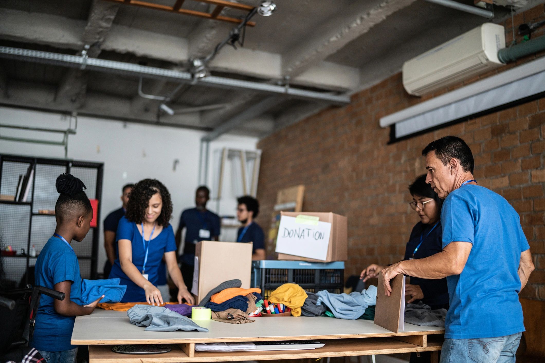 Volunteers arranging donated clothing for community distribution