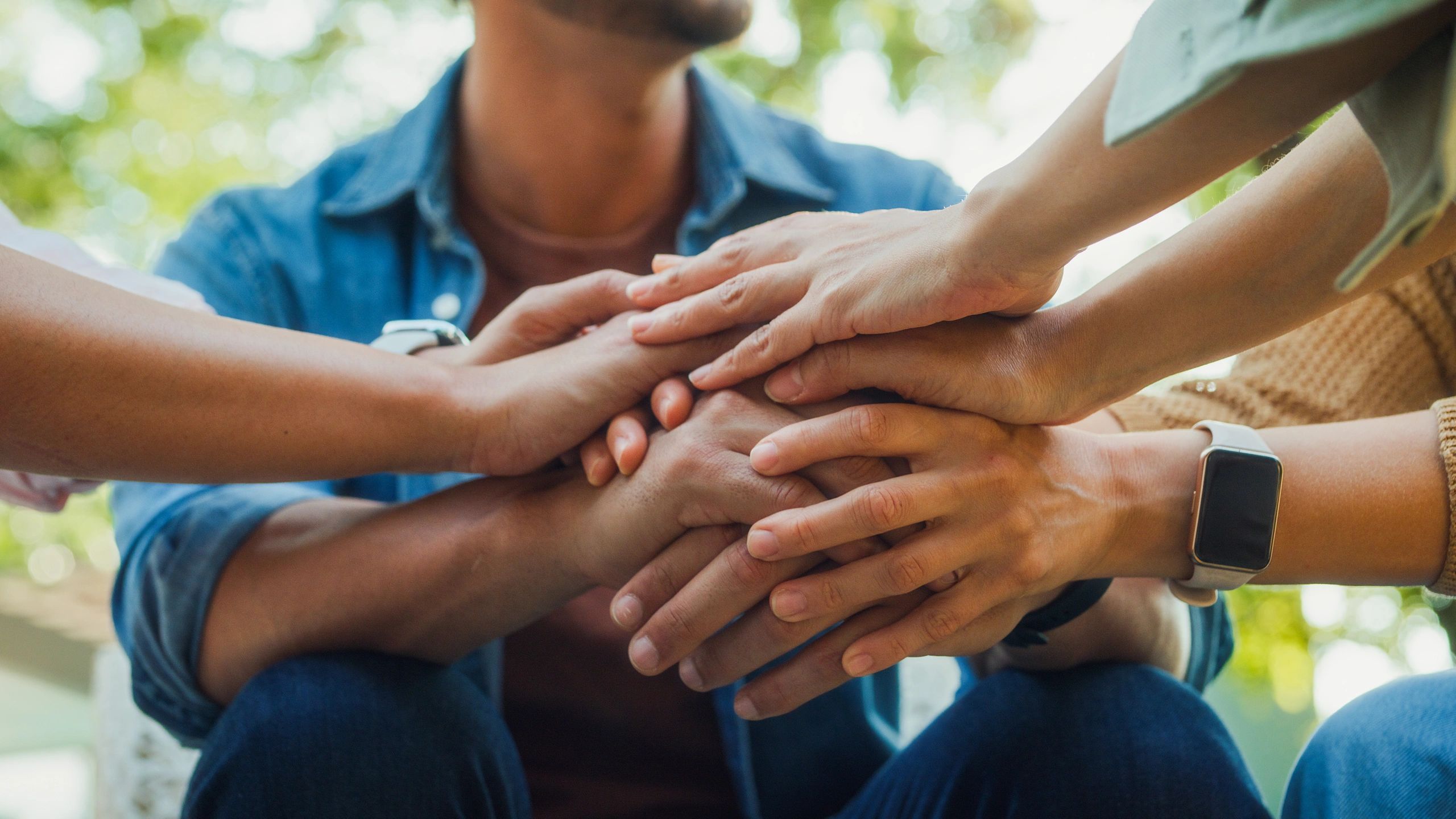 Community members in a supportive group discussion outdoors