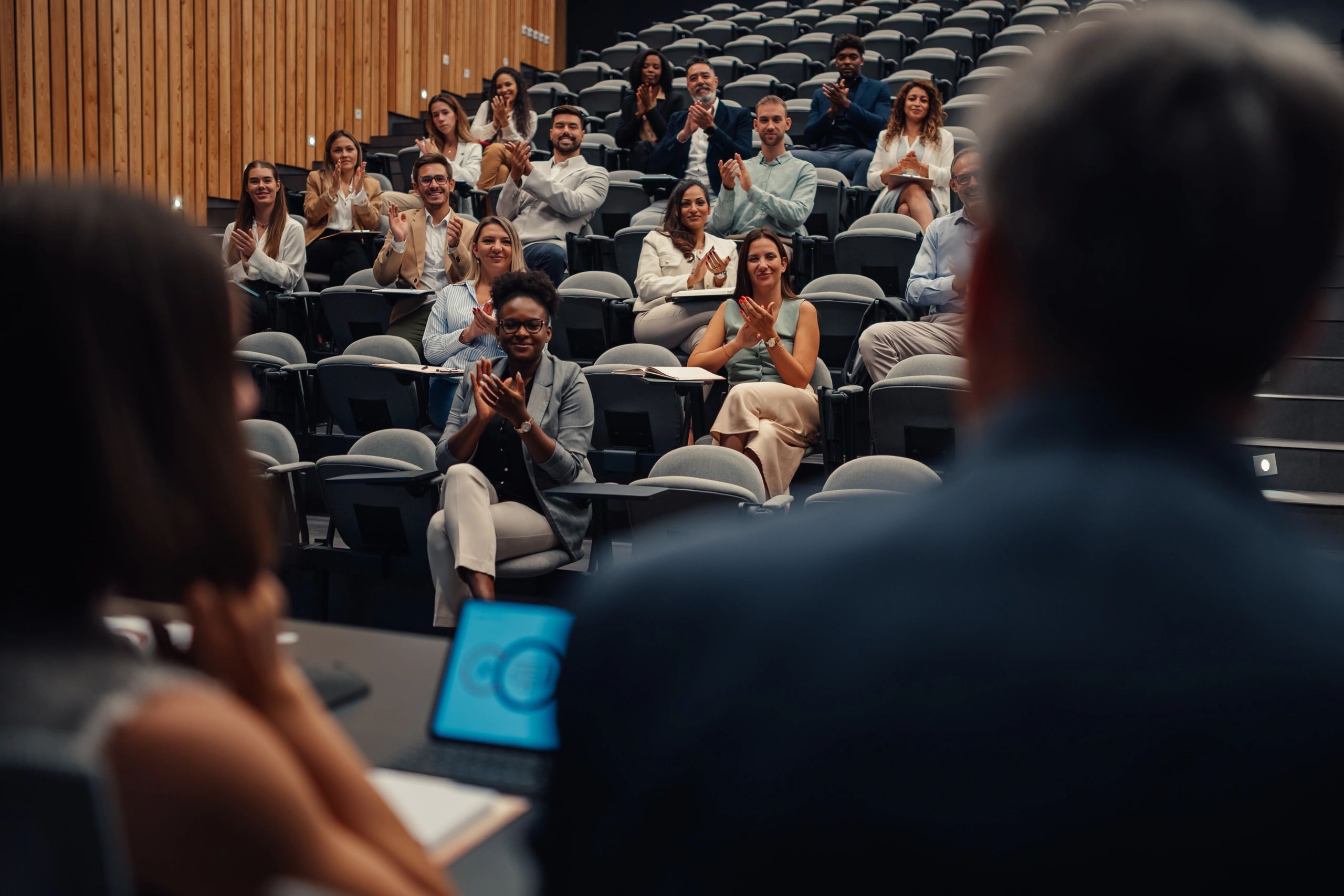 Audience applauding at a community conference event
