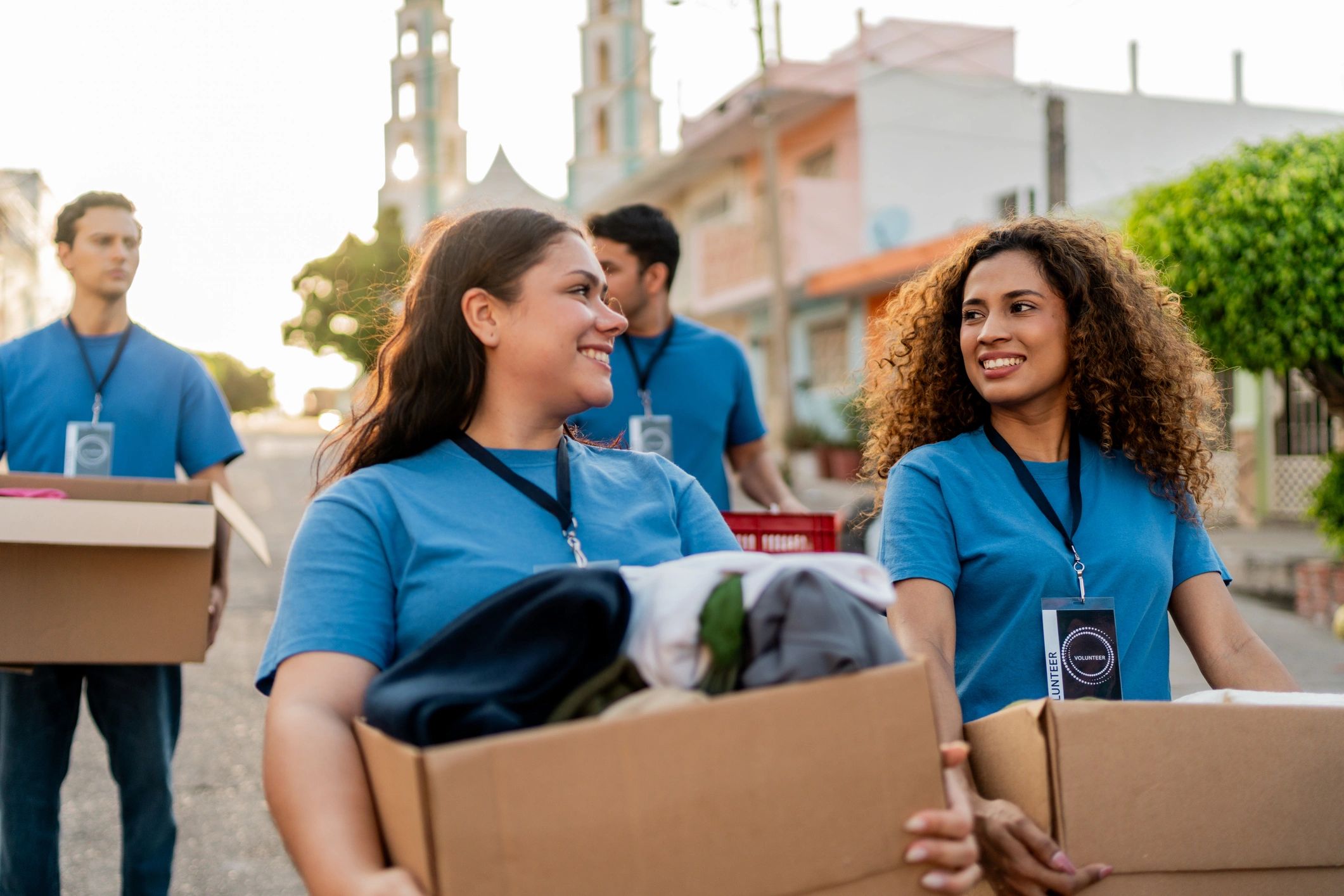 Volunteers carrying donation boxes outdoors together