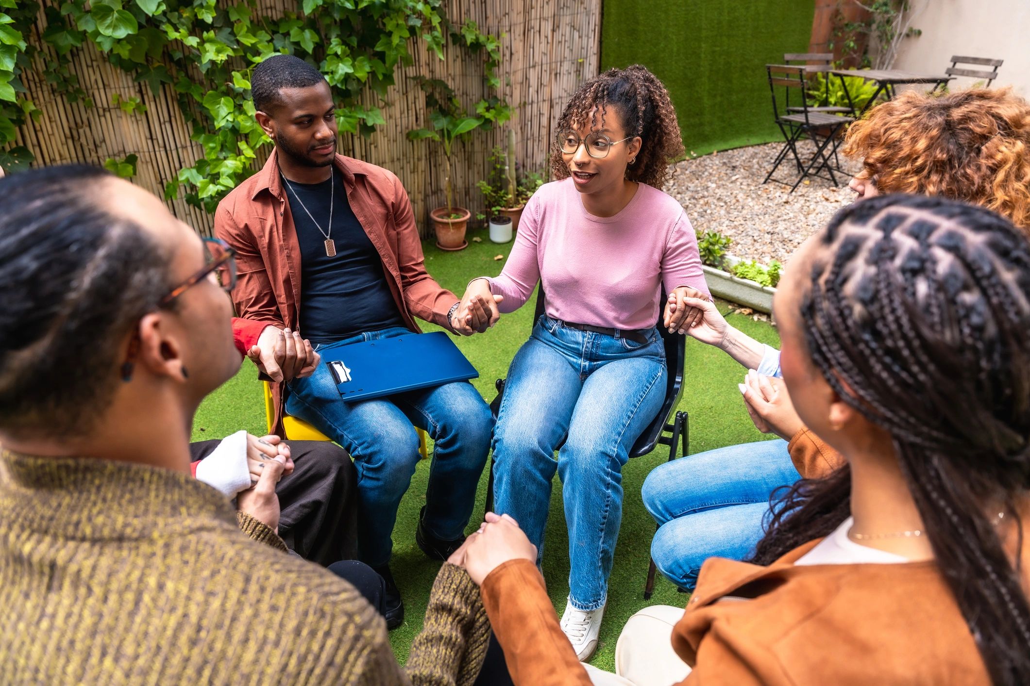 Community members gathered in a supportive circle outdoors